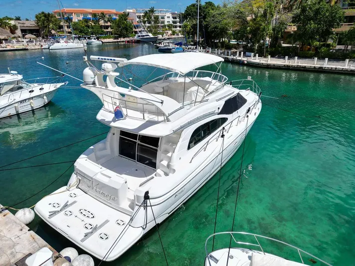  Yacht Photos Pics 2001 Cruisers Yachts 5000 Sedan Sport docked in a serene marina.