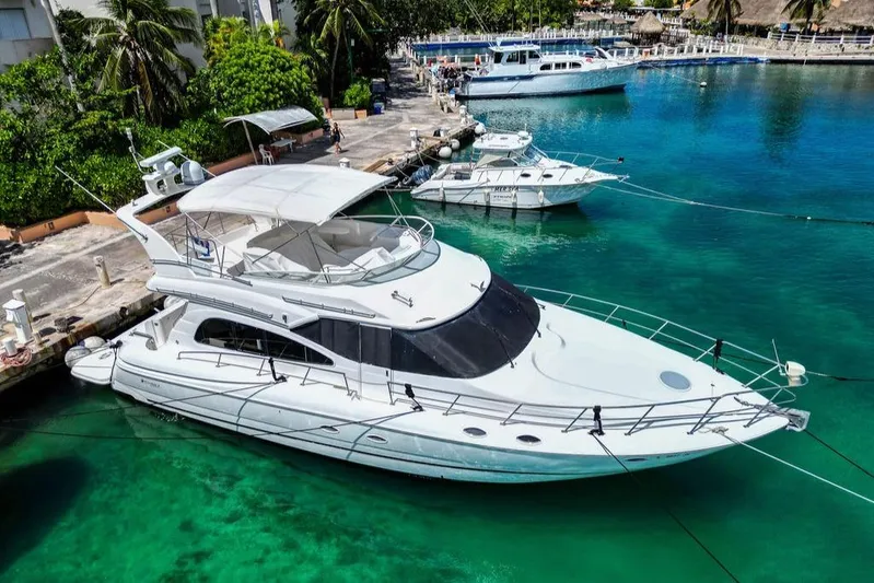  Yacht Photos Pics 2001 Cruisers Yachts 5000 Sedan Sport docked in a tropical marina.