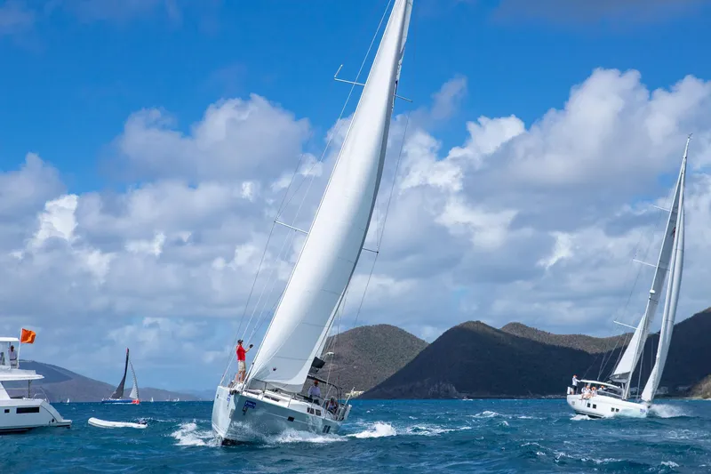 Avalon Sunset Yacht Photos Pics Sailing yachts, including a 2016 Hanse 505, navigating blue waters under a cloudy sky.