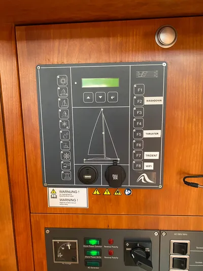 Avalon Sunset Yacht Photos Pics Control panel of a 2016 Hanse 505 yacht with various buttons and warning labels.