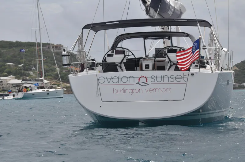 Avalon Sunset Yacht Photos Pics Hanse 505 sailboat, 2016 model, named Avalon Sunset, with American flag, in a scenic harbor.