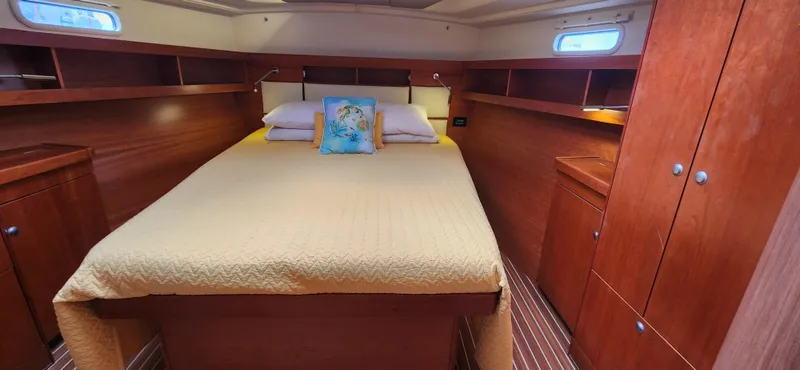 Avalon Sunset Yacht Photos Pics Luxurious cabin interior of 2016 Hanse 505 yacht with wooden furnishings and cozy bedding.