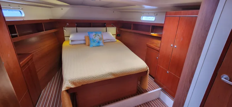 Avalon Sunset Yacht Photos Pics Luxurious cabin interior of 2016 Hanse 505 yacht with wooden furnishings and cozy bedding.