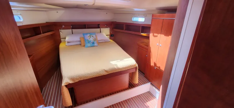 Avalon Sunset Yacht Photos Pics Luxurious cabin interior of 2016 Hanse 505 yacht with cozy bed and wooden furnishings.