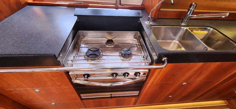 Avalon Sunset Yacht Photos Pics Modern kitchen in a 2016 Hanse 505 yacht with stove and sink.