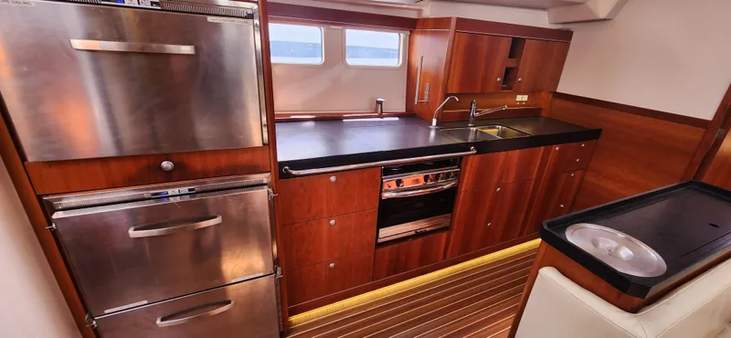 Avalon Sunset Yacht Photos Pics Luxurious 2016 Hanse 505 yacht kitchen with modern appliances and wooden cabinetry.