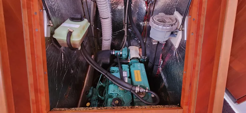 Avalon Sunset Yacht Photos Pics Engine compartment of a 2016 Hanse 505 sailboat, featuring mechanical components and hoses.