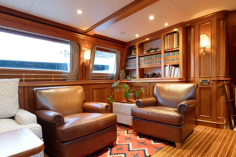 Catalina Yacht Photos Pics Luxurious interior of 2001 Vitters Cruising Ketch with leather chairs and wooden paneling.
