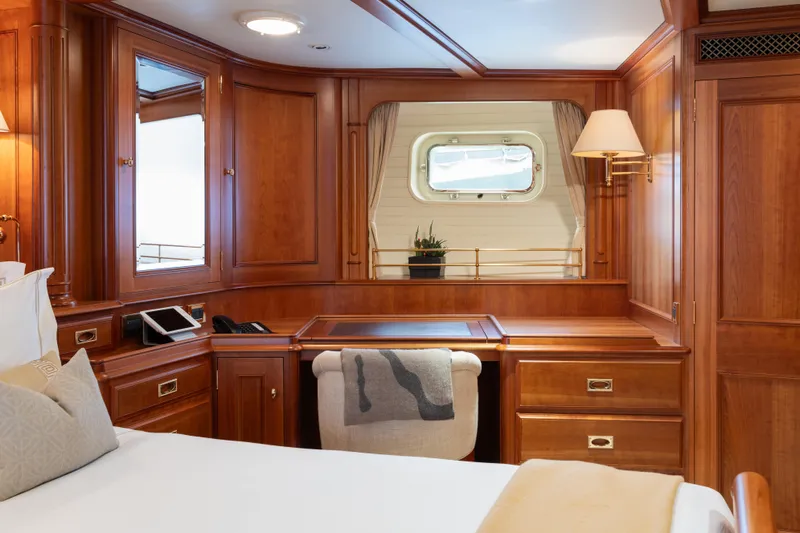 Catalina Yacht Photos Pics Luxurious wooden cabin interior of 2001 Vitters Cruising Ketch yacht with desk and porthole.
