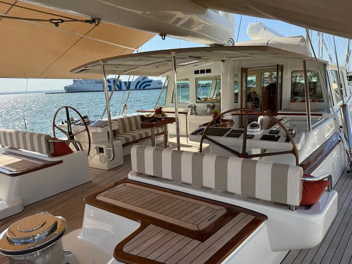 Catalina Yacht Photos Pics Luxurious 2001 Vitters Cruising Ketch yacht deck with striped seating and dual steering wheels.