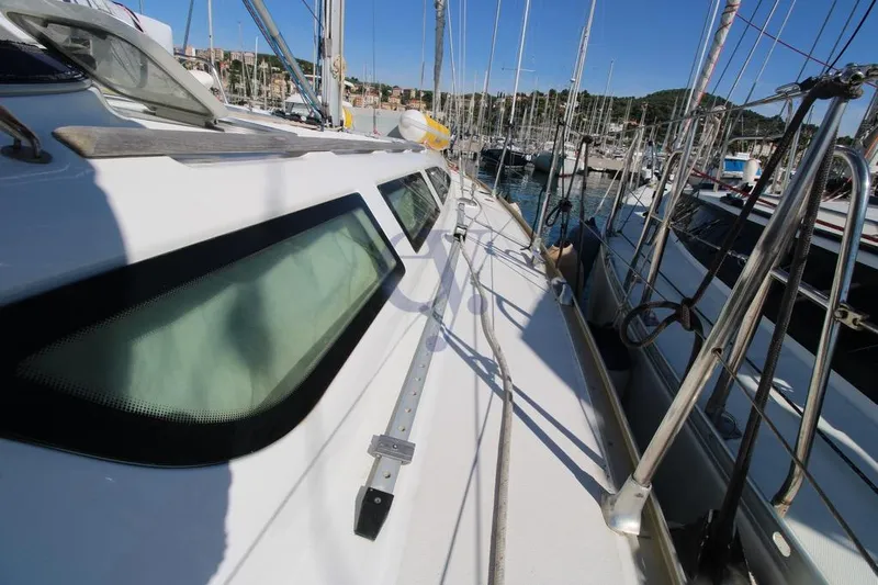  Yacht Photos Pics 2004 Jeanneau Sun Odyssey 40.3 sailboat deck view in marina, showcasing sleek design and rigging.