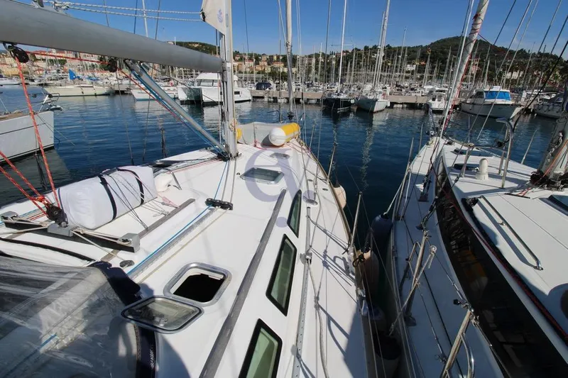  Yacht Photos Pics Jeanneau Sun Odyssey 40.3 sailboat docked in marina, 2004 model, surrounded by other boats.