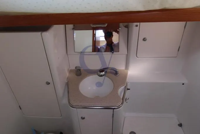  Yacht Photos Pics Bathroom interior of 2004 Jeanneau Sun Odyssey 40.3 yacht with sink and mirror.