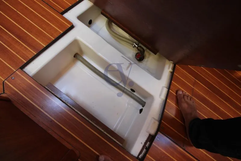  Yacht Photos Pics Open hatch on Jeanneau Sun Odyssey 40.3 sailboat, revealing storage compartment and hose.