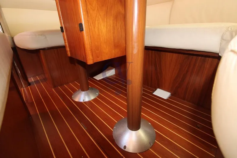  Yacht Photos Pics Interior of 2004 Jeanneau Sun Odyssey 40.3 yacht with wooden flooring and seating.