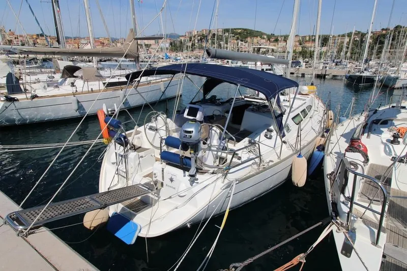  Yacht Photos Pics 2004 Jeanneau Sun Odyssey 40.3 sailboat docked in a marina, surrounded by other boats.