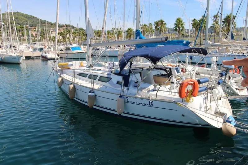  Yacht Photos Pics 2004 Jeanneau Sun Odyssey 40.3 sailboat docked in a marina with clear blue water.