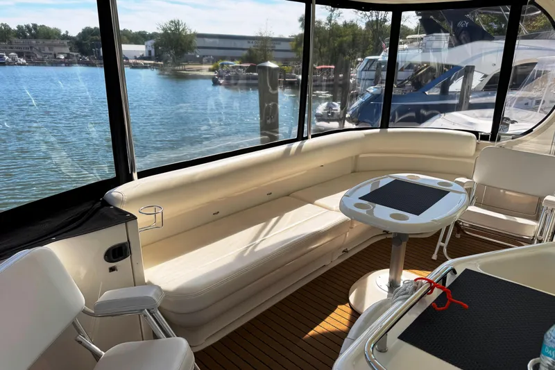  Yacht Photos Pics 2004 Sea Ray 390 Motor Yacht interior with seating and table, overlooking marina.