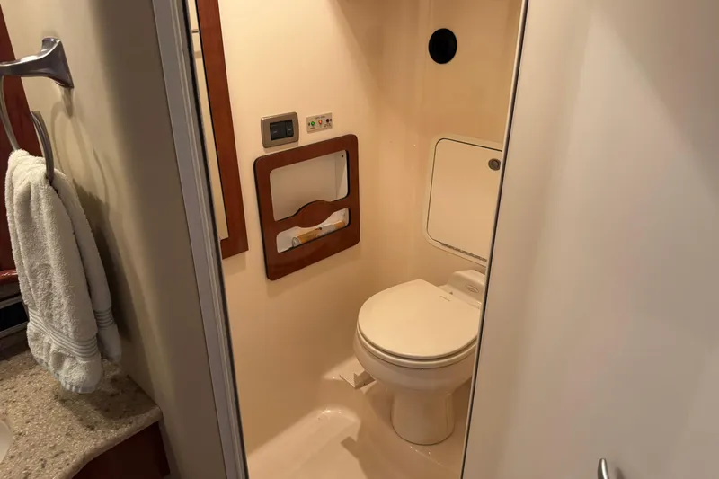  Yacht Photos Pics Bathroom interior of 2004 Sea Ray 390 Motor Yacht, featuring a compact toilet and towel rack.