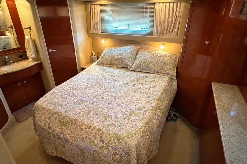  Yacht Photos Pics Luxurious bedroom in 2004 Sea Ray 390 Motor Yacht with elegant bedding and wood finishes.