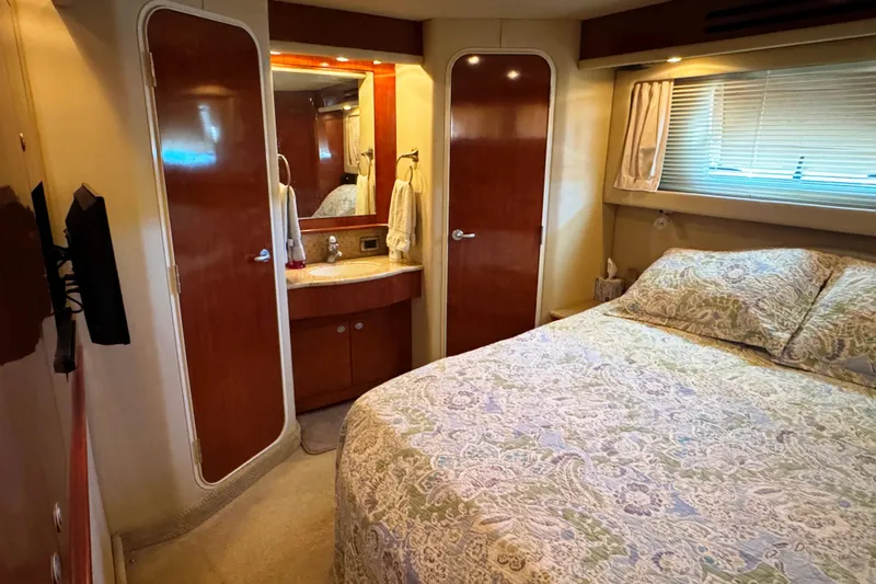  Yacht Photos Pics Luxurious bedroom interior of 2004 Sea Ray 390 Motor Yacht with elegant bedding and wood accents.