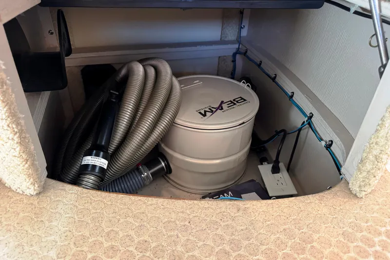  Yacht Photos Pics 2004 Sea Ray 390 Motor Yacht storage compartment with vacuum system and coiled hose.