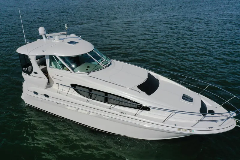  Yacht Photos Pics 2004 Sea Ray 390 Motor Yacht cruising on open water, showcasing sleek design and elegance.