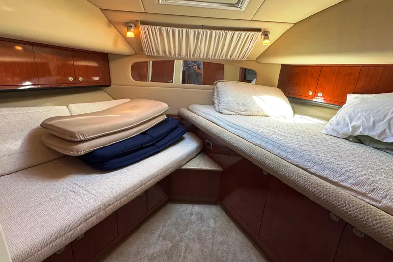  Yacht Photos Pics 2004 Sea Ray 390 Motor Yacht cabin interior with cozy bedding and wooden cabinetry.