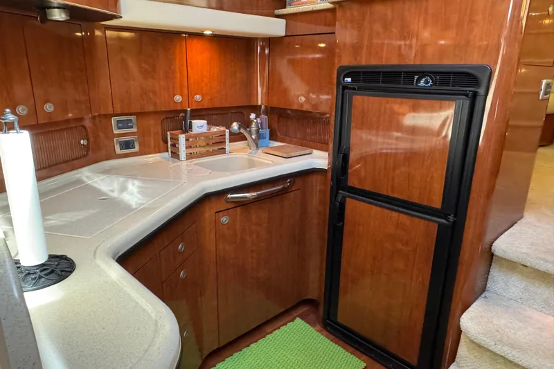  Yacht Photos Pics Luxurious 2004 Sea Ray 390 Motor Yacht kitchen with wood cabinetry and modern appliances.