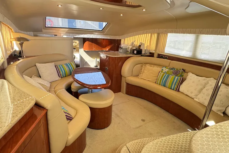  Yacht Photos Pics Luxurious interior of 2004 Sea Ray 390 Motor Yacht with plush seating and elegant decor.
