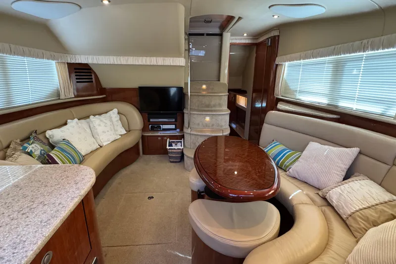  Yacht Photos Pics Luxurious interior of 2004 Sea Ray 390 Motor Yacht with plush seating and elegant decor.