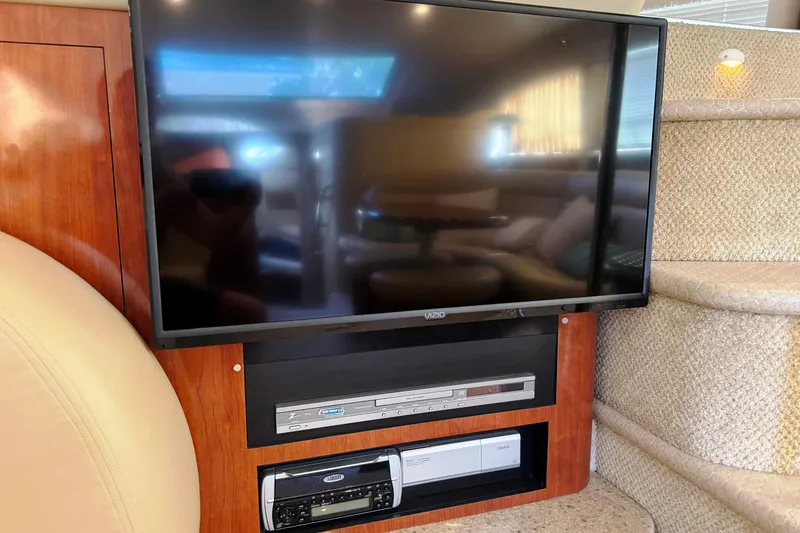  Yacht Photos Pics Flat-screen TV and entertainment system inside 2004 Sea Ray 390 Motor Yacht cabin.