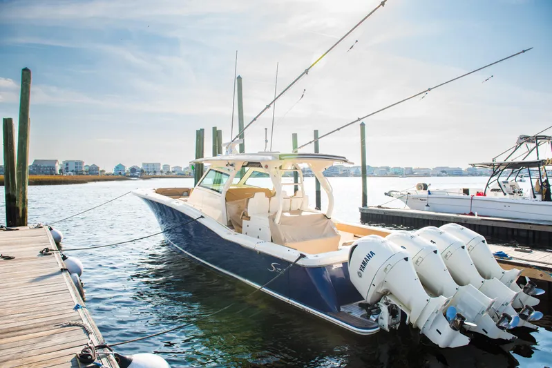  Yacht Photos Pics 2017 Scout 420 LXF boat docked with multiple outboard engines.