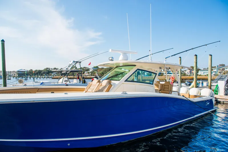  Yacht Photos Pics 2017 Scout 420 LXF boat docked, featuring sleek blue hull and modern design.