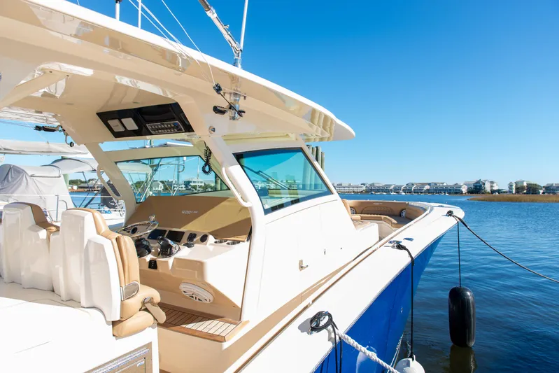  Yacht Photos Pics 2017 Scout 420 LXF boat docked on a sunny day, showcasing luxury design.