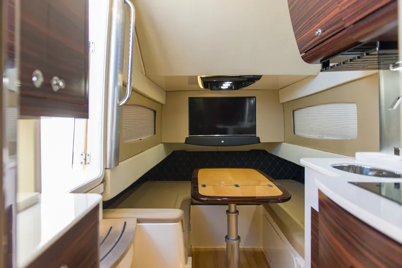  Yacht Photos Pics Luxurious interior of 2017 Scout 420 LXF boat with seating, table, and TV.