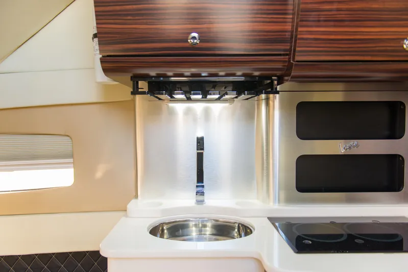  Yacht Photos Pics 2017 Scout 420 LXF interior kitchen with sink, stove, and wooden cabinets.