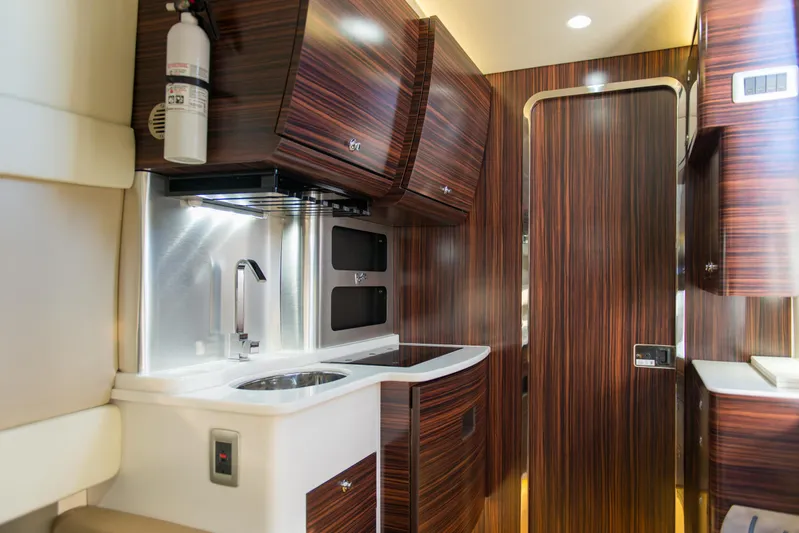  Yacht Photos Pics Luxurious interior of 2017 Scout 420 LXF boat with modern wood finish and kitchenette.