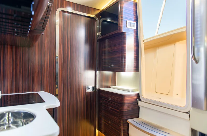  Yacht Photos Pics Interior of 2017 Scout 420 LXF boat with modern wood finish and sleek cabinetry.