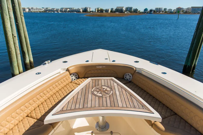  Yacht Photos Pics Bow view of 2017 Scout 420 LXF boat with luxurious seating and wooden table.