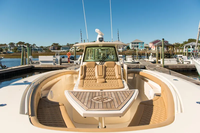  Yacht Photos Pics 2017 Scout 420 LXF luxury boat docked at marina, showcasing elegant seating and design.