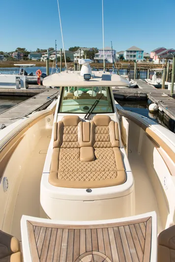  Yacht Photos Pics 2017 Scout 420 LXF luxury boat with tan seating at a marina.