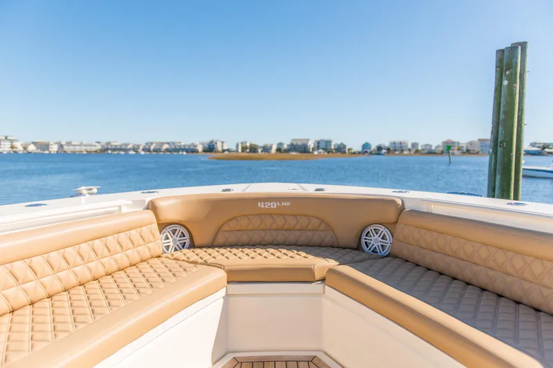  Yacht Photos Pics Luxurious seating on 2017 Scout 420 LXF boat with waterfront view.