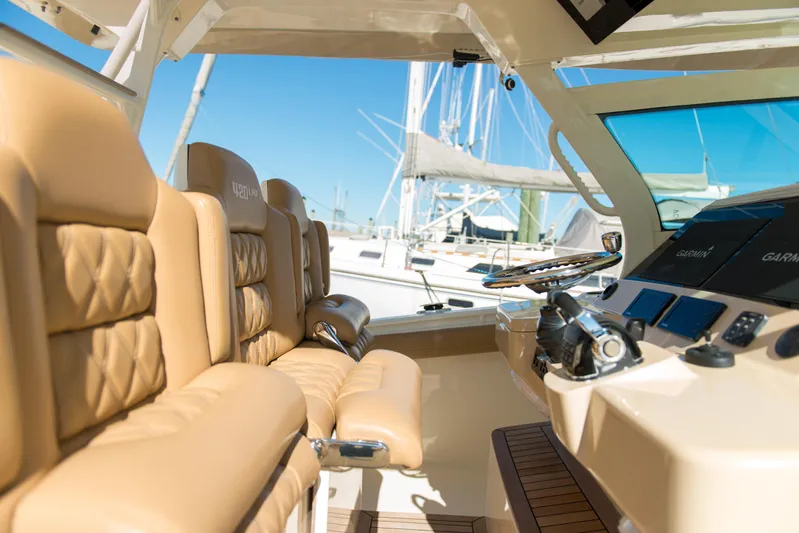  Yacht Photos Pics Luxurious interior of 2017 Scout 420 LXF boat with tan leather seating and modern controls.