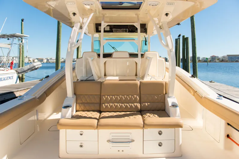  Yacht Photos Pics Luxurious 2017 Scout 420 LXF boat interior with tan seating and storage, docked by the water.