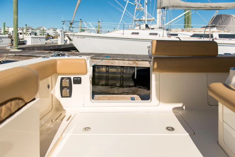  Yacht Photos Pics 2017 Scout 420 LXF boat interior with tan seating and dock view.