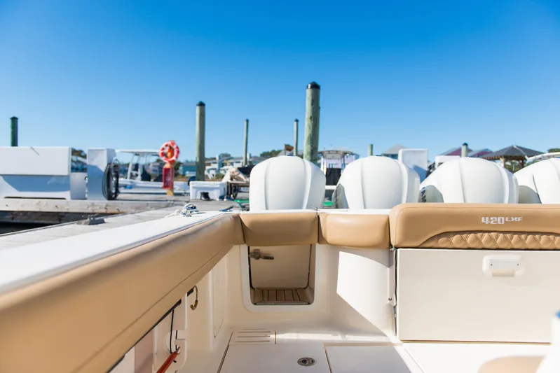 Yacht Photos Pics 2017 Scout 420 LXF boat interior with engines, docked under clear blue sky.