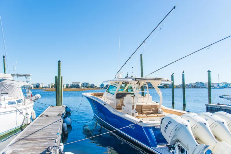  Yacht Photos Pics 2017 Scout 420 LXF boat docked with clear blue sky background.