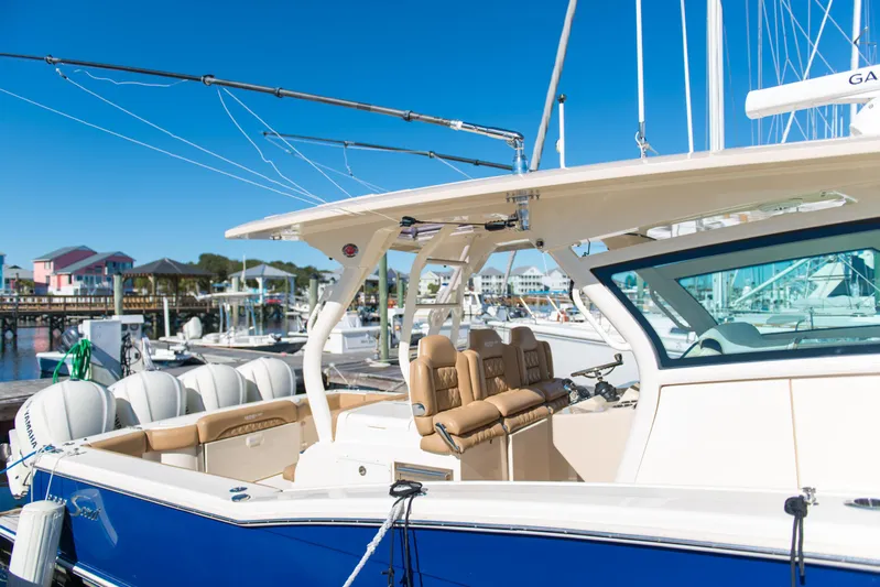  Yacht Photos Pics 2017 Scout 420 LXF boat docked, featuring luxurious seating and sleek design.