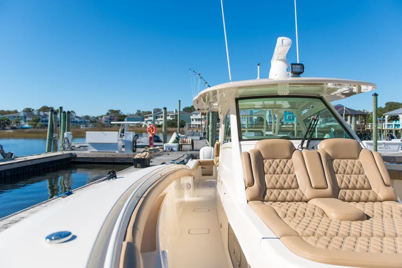  Yacht Photos Pics 2017 Scout 420 LXF luxury boat docked at marina under clear blue sky.